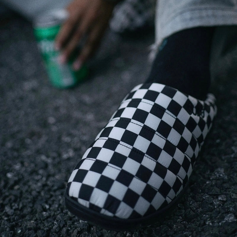 Close-up of Subu I F-Line Checker slip-on shoes with a black and white checker pattern.